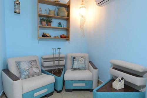 a living room with two chairs and a table at viktoryadream in Eilat
