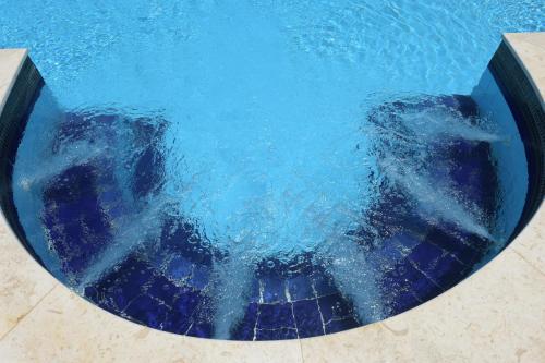a pool of blue water with a person in it at viktoryadream in Eilat