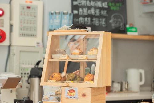 a display case filled with different types of food at Corner Hostel & Cafe in Taipei