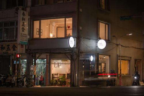 a building with windows on a city street at night at Corner Hostel & Cafe in Taipei