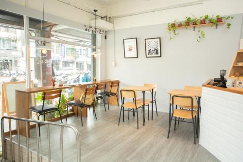 a restaurant with tables and chairs in a room at Corner Hostel & Cafe in Taipei