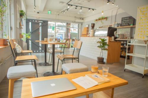a table with a laptop on it in a room at Corner Hostel & Cafe in Taipei
