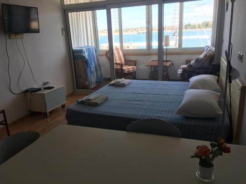 a bedroom with a bed and a view of the ocean at Apartment Bellavista - Umag in Umag