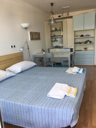 a bedroom with a bed with two towels on it at Apartment Bellavista - Umag in Umag