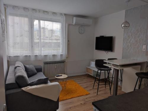 a living room with a couch and a table at Apartman Emy in Karlovac