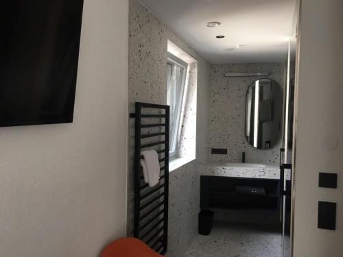 a bathroom with a ladder leading to a sink and a mirror at Boutique Hotel Edelweiss in Sankt Anton am Arlberg