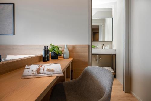 a bedroom with a desk with a chair and a mirror at Hotel San Marco in Cattolica