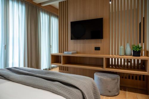 a bedroom with a bed and a tv on a wall at Hotel San Marco in Cattolica