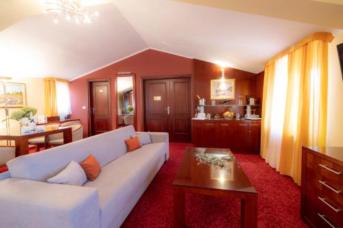 a living room with a white couch and a table at Villa Riva in Makarska