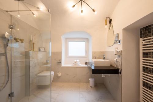 a bathroom with a toilet and a sink and a shower at Smarthotel Völkermarkt in Völkermarkt