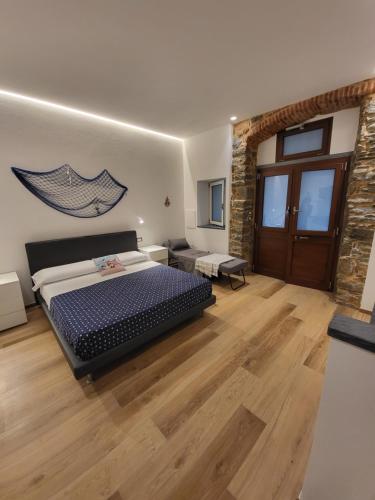 a bedroom with a bed and a wooden floor at Bianca Luna in Manarola
