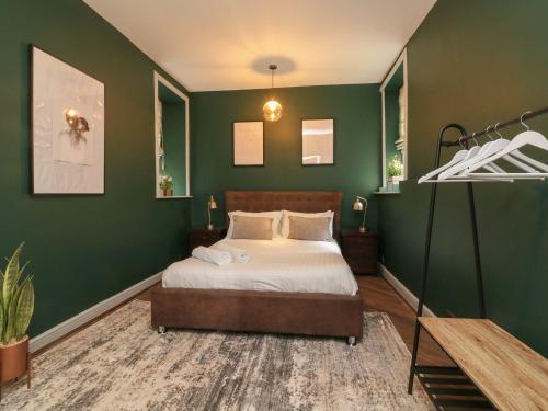 a bedroom with green walls and a bed at Westwell Hall Guest Accommodation, Bed & Breakfast, Luxury Rooms - Room Only Accommodation OR Self Catered Apartment in Ilfracombe