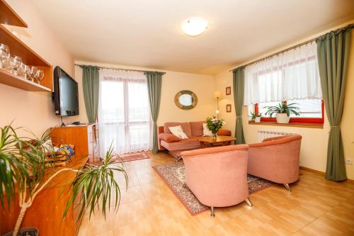 a living room with a couch and a table at Penzion Sinfonietta in Luhačovice
