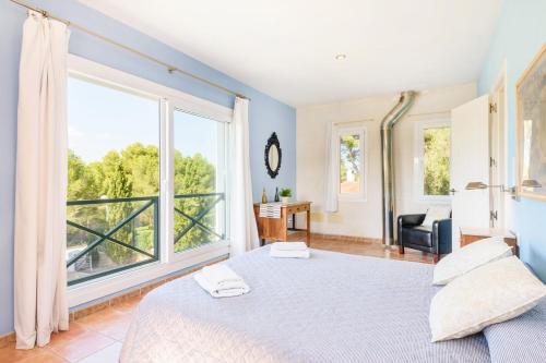 a bedroom with a bed and a large window at Villa Serafina by Villa Plus in Son Parc