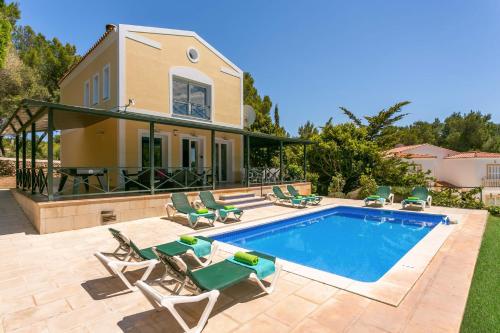 a villa with a swimming pool and a house at Villa Serafina by Villa Plus in Son Parc