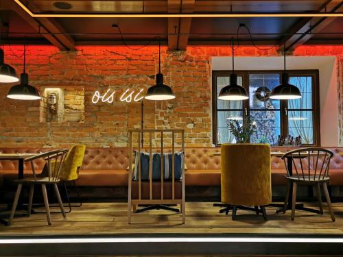 a restaurant with a brick wall and tables and chairs at Zur Mühle in Bad Birnbach