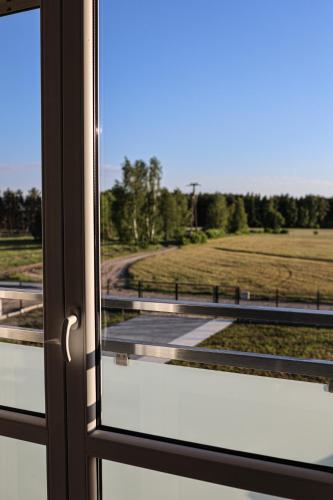 a window with a view of a field behind it at Lasy Jeziora, Cisza i Spokój, Grzybki i Rybki, Dom 180m2 w Swornegacie nad jeziorem Karsińskim in Swornegacie 