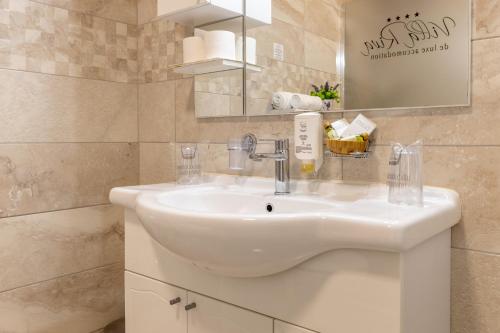 a bathroom with a white sink and a mirror at Villa Riva in Makarska
