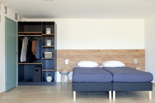 a bedroom with a blue bed and a closet at Livingfy Apt with mountain view & garden in Vamos