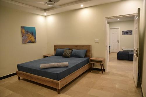 a bedroom with a king sized bed in a room at The Bliss in Rawalpindi