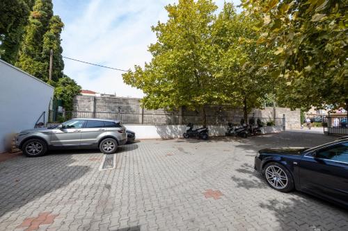 two cars are parked in a parking lot at Villa Riva in Makarska