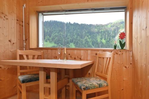 a kitchen with a table and chairs and a window at Appartements Willi in Schoppernau