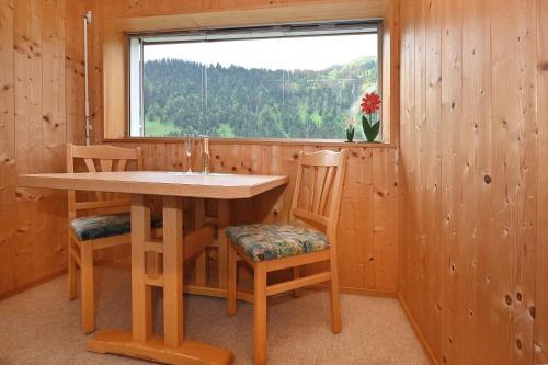 a room with a table and two chairs and a window at Appartements Willi in Schoppernau