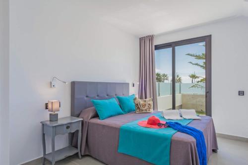 sypialnia z łóżkiem i widokiem na ocean w obiekcie Villa Alana by Villa Plus w Corralejo