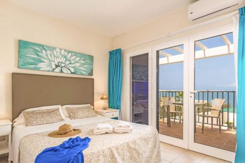 a bedroom with a bed with a view of the ocean at Villa Isabella by Villa Plus in Corralejo
