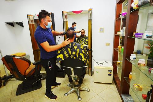 a man getting his hair cut in a salon at Falcon Hills Hotel in Sharm El Sheikh