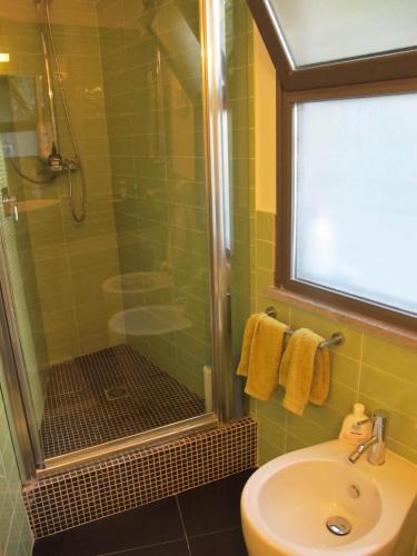 a bathroom with a shower and a sink and a shower at Villa Le Lanterne Pool & Relax in Mondello