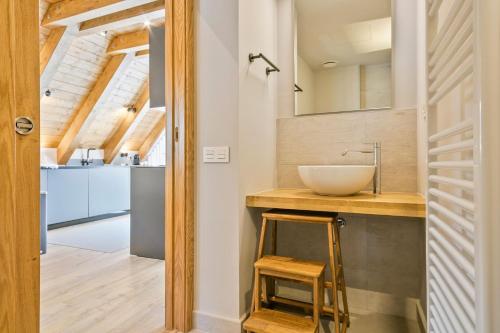 a bathroom with a sink and a mirror at Luderna - Casa Peregrí in Arties