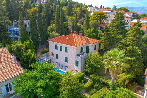 an aerial view of a house with a palm tree at Stone Villa Majestic w Pool - Split Center in Split