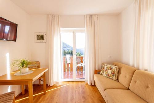 a living room with a couch and a table at Haus Lohengrin Ferienwohnung 1 in Siusi