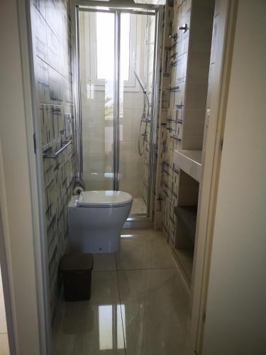 a bathroom with a shower and a toilet in it at Hotel Mare Blu in Torre dell'Orso