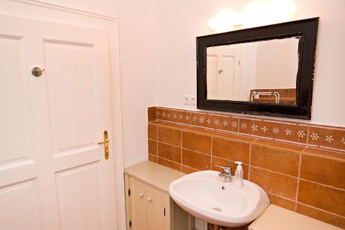 a bathroom with a sink and a mirror at Barta Pince Vendégház Mád in Mád