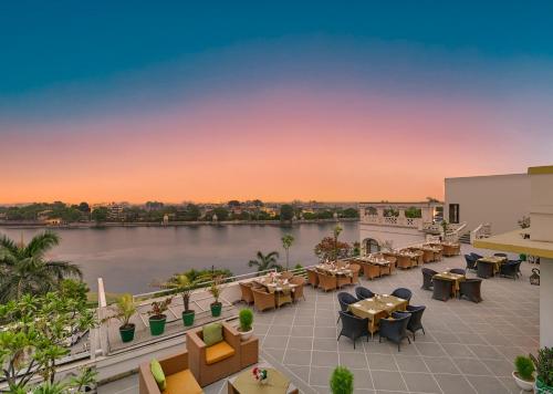 a view of the patio of a hotel with tables and chairs at Brahma Niwas - Best Lake View Hotel in Udaipur in Udaipur