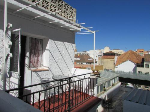a balcony with a table and chairs on a building at Hostal Nevada in Fuengirola