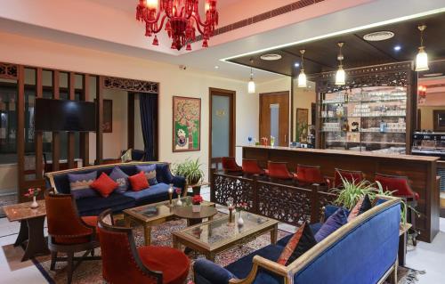 a lobby with a bar with blue couches at Brahma Niwas - Best Lake View Hotel in Udaipur in Udaipur