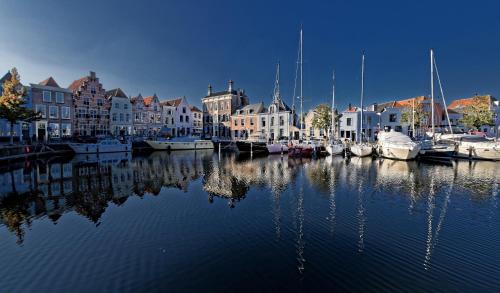 a group of boats are docked in a harbor at HARBOR HOUSE ZEELAND - nl in Goes