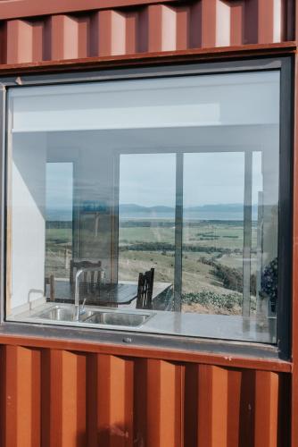 a kitchen window with a sink and a view at One Tree Hill Wilson prom and Ocean views in Toora