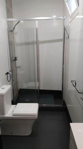 a bathroom with a shower and a white toilet at Forever São Brás in São Brás de Alportel