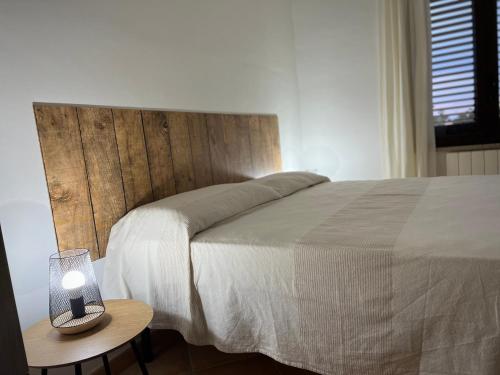 a bedroom with a bed and a table with a lamp at Villa con piscina TERRAZZA DAL PICCIOTTO in Marsala