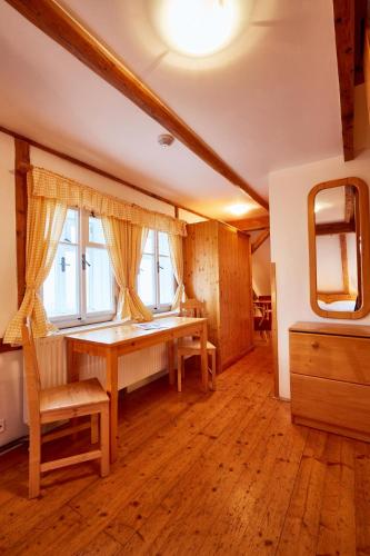 a room with a wooden table and a window at Pyramida - Jizerka in Jizerka