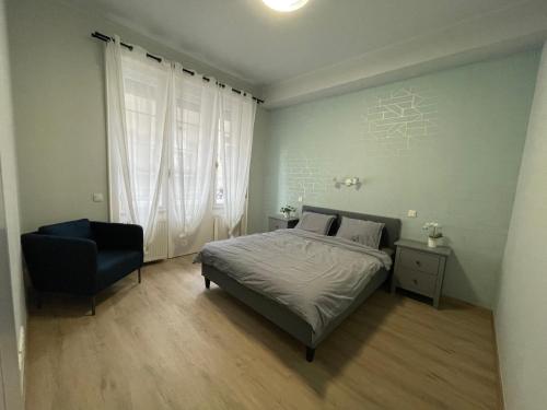 1 dormitorio con 1 cama y 1 silla en Astoria Downtown Superior, en Budapest