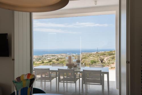 a dining room with a view of the ocean at Noble 7 Suites - Adults Only - Onar Hotels Collection in Parikia