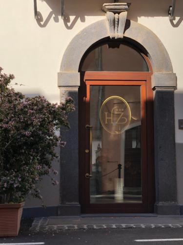 a door to a building with a sign on it at Hotel Zodiaco in Bolsena