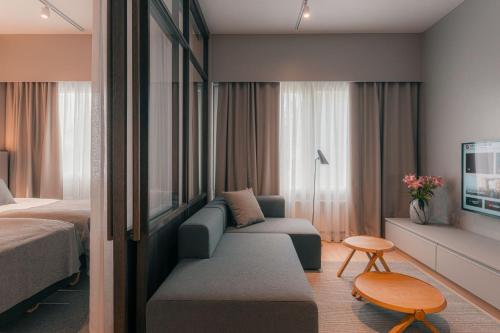 a hotel room with a couch and a bed at Original Sokos Hotel Seurahuone Savonlinna in Savonlinna
