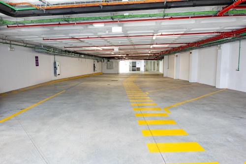 an empty parking garage with yellow lines on the floor at YOTEL Porto in Porto