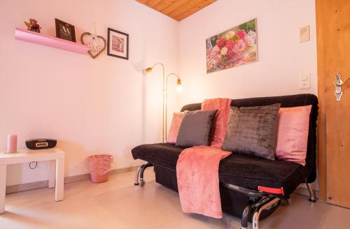 a living room with a couch with pillows on it at Haus Padrun 6 in Arosa